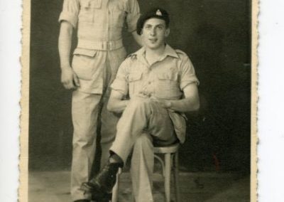 Two men, one sitting in a chair and one standing