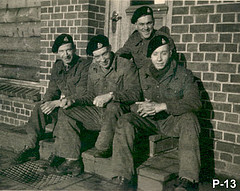 Group of men in uniform sitting on stoop